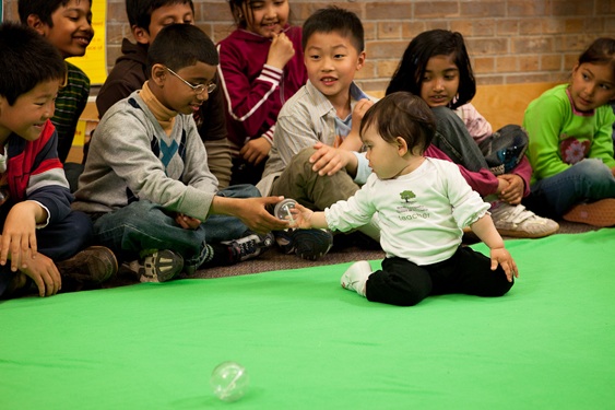 Image of baby interacting with students in roots of empathy program